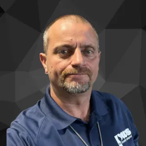 Headshot of man in blue collared shirt