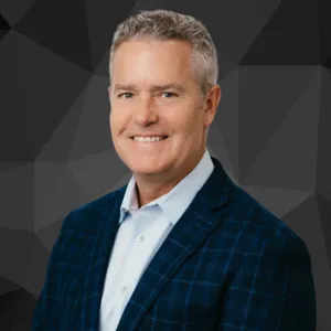 Smiling man in blue blazer headshot