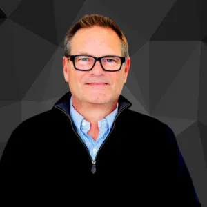 Headshot of man with glasses, geometric background
